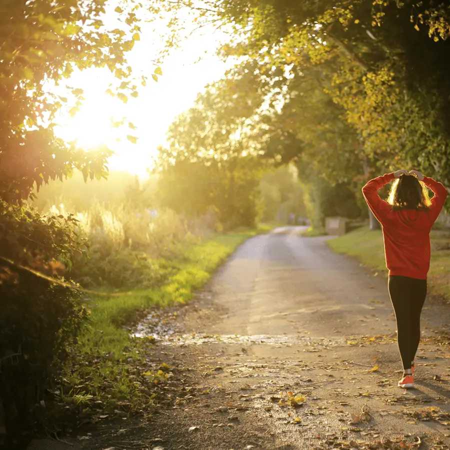 Rivermate | The girl runs along the road in the forest